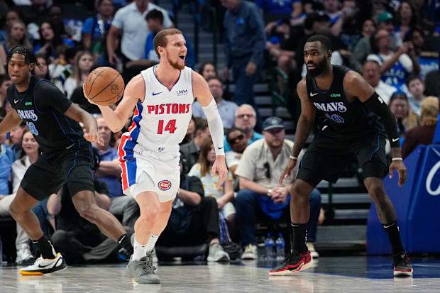 Detroit Pistons guard Malachi Flynn (14)  controls the ball as Dallas Mavericks forward Tim Hardaway Jr. (10).