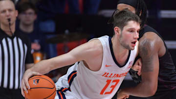 Nov 23, 2024; Champaign, Illinois, USA;  Illinois Fighting Illini center Tomislav Ivisic (13) drives the ball against Maryland-Eastern Shore Hawks forward Christopher Flippin (35) during the second half at State Farm Center. Mandatory Credit: Ron Johnson-Imagn Images