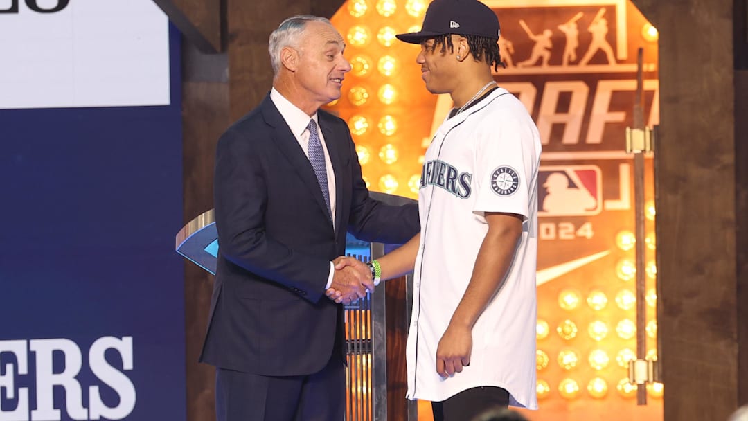 Jul 14, 2024; Ft. Worth, TX, USA;  MLB Commissioner Rob Manfred takes a photo with Jurrangelo Cijntje after being drafted by the Seattle Mariners with the 15th pick during the first round of the MLB Draft at Cowtown Coliseum. Mandatory Credit: Kevin Jairaj-Imagn Images