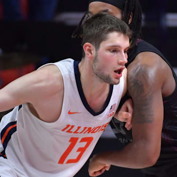 Nov 23, 2024; Champaign, Illinois, USA;  Illinois Fighting Illini center Tomislav Ivisic (13) drives the ball against Maryland-Eastern Shore Hawks forward Christopher Flippin (35) during the second half at State Farm Center. Mandatory Credit: Ron Johnson-Imagn Images