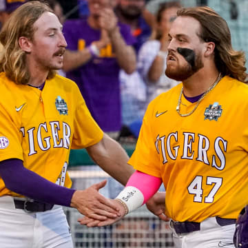 Jun 24, 2023; Omaha, NE, USA; LSU Tigers third baseman Tommy White (47) and right fielder Paxton Kling (28) celebrate after a home run by White against the Florida Gators during the eighth inning at Charles Schwab Field Omaha. Mandatory Credit: Dylan Widger-USA TODAY Sports
