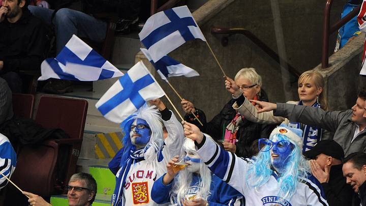Finland hockey fans wave their flags during a game at the 2010 Winter Olympics