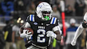 Nov 29, 2025; Durham, North Carolina, USA;  Duke Blue Devils wide receiver Sahmir Hagans (2) runs the ball against Wake Forest Demon Deacons linebacker Whittman Whaley (40) during the fourth quarter at Wallace Wade Stadium. Mandatory Credit: Zachary Taft-Imagn Images