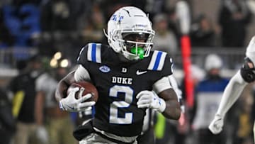 Nov 29, 2025; Durham, North Carolina, USA;  Duke Blue Devils wide receiver Sahmir Hagans (2) runs the ball against Wake Forest Demon Deacons linebacker Whittman Whaley (40) during the fourth quarter at Wallace Wade Stadium. Mandatory Credit: Zachary Taft-Imagn Images