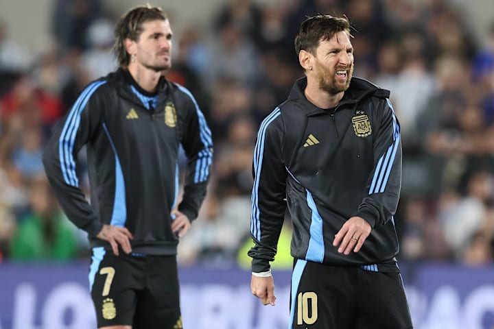 Rodrigo de Paul (left) and Lionel Messi.