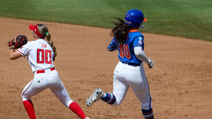 Florida starting pitcher/relief pitcher Ava Brown (00) gets thrown out at first by Texas Tech infielder Jackie Lis (00) during game 2 of the super regional of the NCAA Division 1 softball championship at Katie Seashole Pressly Stadium in Gainesville, FL on Saturday, May 23, 2026. [Alan Youngblood/Gainesville Sun]