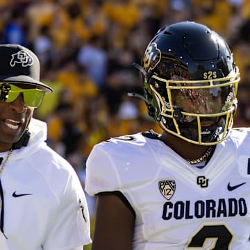 Oct 7, 2023; Tempe, Arizona, USA; Colorado Buffaloes head coach Deion Sanders with son and quarterback Shedeur Sanders (2) against the Arizona State Sun Devils at Mountain America Stadium.