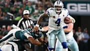 Dallas Cowboys quarterback Dak Prescott avoids a sack by Philadelphia Eagles DT Jordan Davis and LB Patrick Johnson.