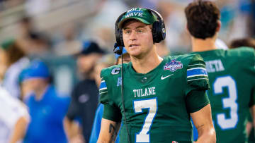 Dec 2, 2023; New Orleans, LA, USA; Tulane Green Wave quarterback Michael Pratt (7) talks to the coaching staff on the headset when Southern Methodist Mustangs is on the field during the first half at Yulman Stadium. Mandatory Credit: 