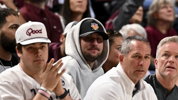 Former NFL quarterback Johnny Manziel sits court side during the game between the Texas A&M Aggies and the Auburn Tigers