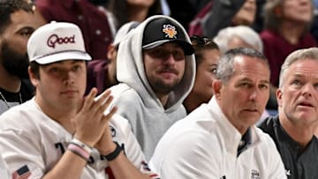 Former NFL quarterback Johnny Manziel sits court side during the game between the Texas A&M Aggies and the Auburn Tigers