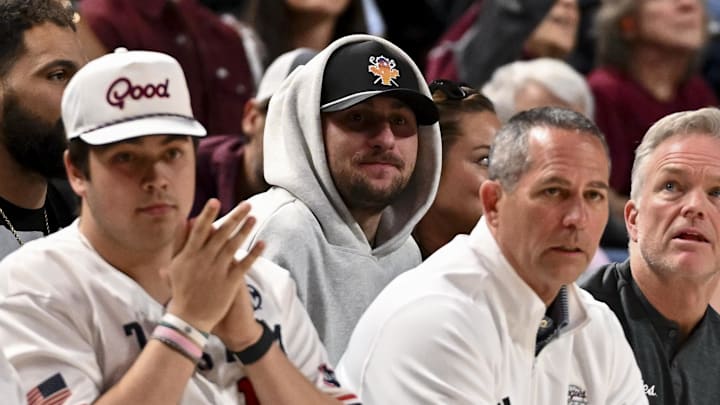 Former NFL quarterback Johnny Manziel sits court side during the game between the Texas A&M Aggies and the Auburn Tigers Former NFL quarterback Johnny Manziel sits court side during the game between the Texas A&M Aggies and the Auburn Tigers