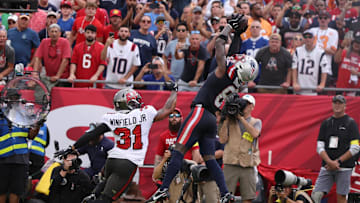 Nov 9, 2025; Tampa, Florida, USA; New England Patriots wide receiver Stefon Diggs (8) catches a touchdown pass under pressure from Tampa Bay Buccaneers safety Antoine Winfield Jr. (31) during the second quarter at Raymond James Stadium. Mandatory Credit: Nathan Ray Seebeck-Imagn Images
