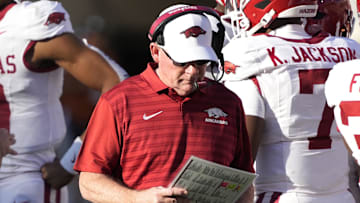 Arkansas Razorbacks interim coach Bobby Petrino looks at his notes during the first half against the Texas Longhorns at Darrell K Royal-Texas Memorial Stadium. 