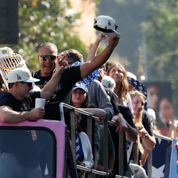Nov 1, 2024; Los Angeles, CA, USA;  Los Angeles Dodgers manager Dave Roberts celebrates with the Commissioner’s Trophy during the 2024 World Series Championship parade in downtown Los Angeles.  Mandatory Credit: Kiyoshi Mio-Imagn Images