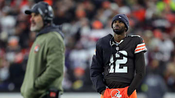 Cleveland Browns quarterback Shedeur Sanders (12) waits for his opportunity as head coach Kevin Stefanski watches Dillon Gabriel lead the offense during the first half of an NFL football game at Huntington Bank Field, Nov. 16, 2025, in Cleveland, Ohio.
