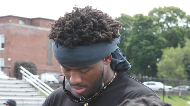 Stepinac graduate and Las Vegas Raiders defensive end Malcom Koonce signs an autograph for one of the young athletes at a free youth football camp that he hosted at Archbishop Stepinac High School in White Plains July 20, 2024.