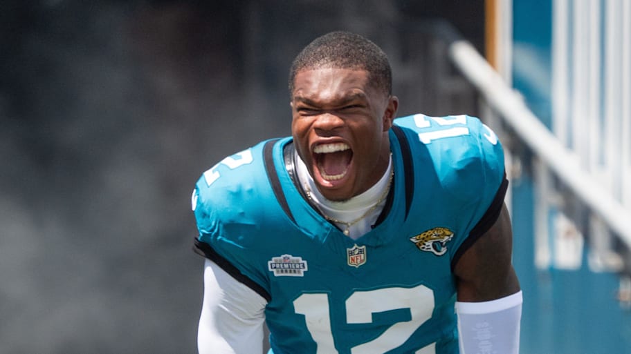 Travis Hunter yells while emerging from the tunnel ahead of his Jaguars debut.