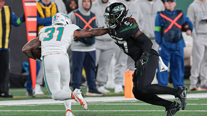 Nov 24, 2023; East Rutherford, New Jersey, USA; Miami Dolphins running back Raheem Mostert (31) is tackled by New York Jets linebacker C.J. Mosley (57) during the second half at MetLife Stadium. 