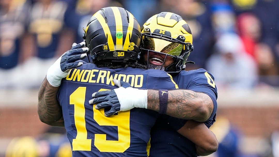 Michigan quarterback Bryce Underwood (19) hugs defensive lineman Tré Williams (0) before the first half of the spring game at Michigan Stadium in Ann Arbor on Saturday, April 19, 2025.