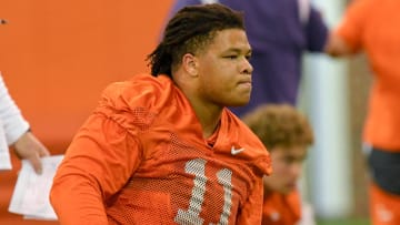 Clemson defensive lineman Peter Woods (11) stretches during the first day of Spring practice at the Poe Indoor Practice Facility at the Allen N. Reeves football complex in Clemson S.C. Wednesday, February 28, 2024.