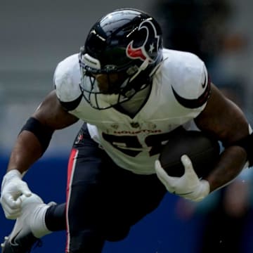 Houston Texans running back Joe Mixon (28) dodges a tackle by Indianapolis Colts cornerback JuJu Brents (29) on Sunday, Sept. 8, 2024, during a game against the Houston Texans at Lucas Oil Stadium in Indianapolis.