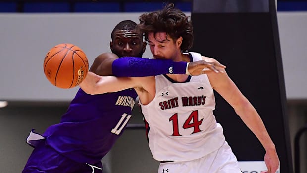 Huskies center Franck Kepnang (11) and St. Mary's forward Kyle Bowen (14) battle in this 2022 game.
