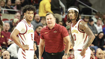 Jan 21, 2025; Ames, Iowa, USA; Iowa State Cyclones head coach T.J. Otzelberger talks with Iowa State Cyclones guard Curtis Jones (5) and Iowa State Cyclones guard Keshon Gilbert (10) during the second half of their game with the UCF Knights at James H. Hilton Coliseum. Mandatory Credit: Reese Strickland-Imagn Images