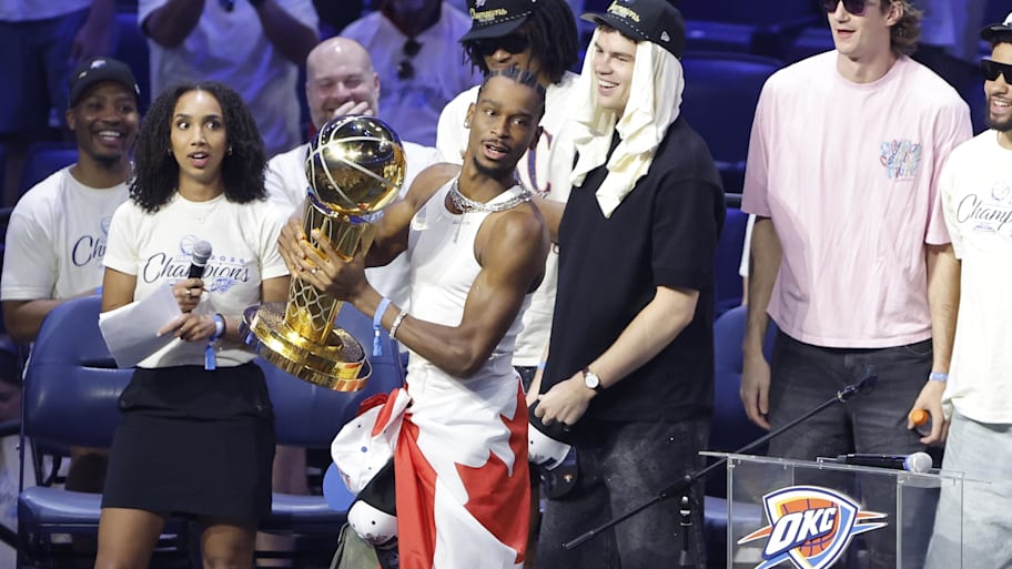 Shai Gilgeous-Alexander holds the trophy at the Oklahoma City Thunder’s championship parade.  | Alonzo Adams-Imagn Images