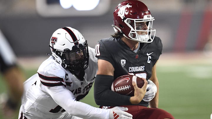 Sep 7, 2024; Pullman, Washington, USA; Washington State Cougars quarterback John Mateer, right, is caught from behind by Texas Tech Red Raiders linebacker Jacob Rodriguez (10) in the second half at Gesa Field at Martin Stadium. Washington State Cougars won 37-16. Mandatory Credit: James Snook-Imagn Images