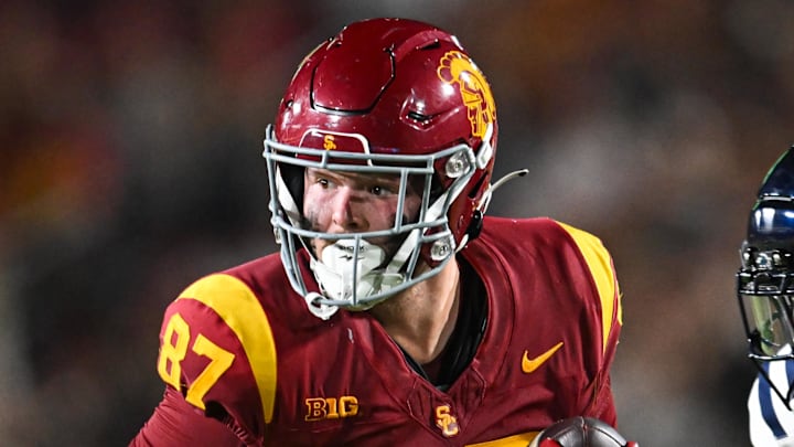Sep 7, 2024; Los Angeles, California, USA; USC Trojans tight end Lake McRee (87) runs the ball against Utah State Aggies cornerback D.J. Graham II (4) during the second quarter at United Airlines Field at Los Angeles Memorial Coliseum. Mandatory Credit: Jonathan Hui-Imagn Images