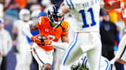 Dec 15, 2024; Denver, Colorado, USA; Denver Broncos cornerback Pat Surtain II (2) returns an interception in the fourth quarter against the Indianapolis Colts at Empower Field at Mile High. 