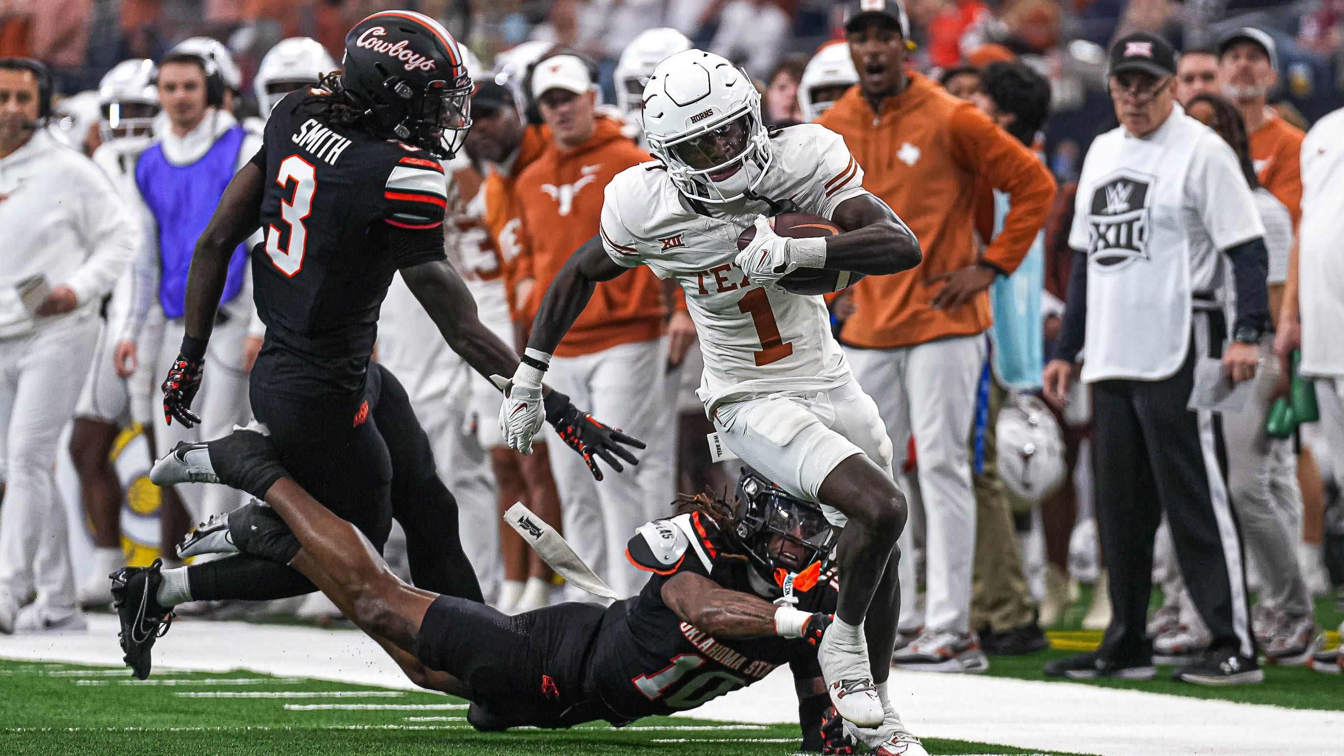 Texas Longhorns wide receiver Xavier Worthy (1) runs the ball down the sideline during the Big 12 championship game.