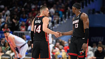 Mar 31, 2025; Washington, District of Columbia, USA; Miami Heat guard Tyler Herro (14) and center Bam Adebayo (13) react during the third quarter against the Washington Wizards at Capital One Arena. Mandatory Credit: Reggie Hildred-Imagn Images
