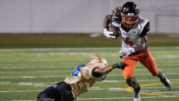 Cocoa's Latrison Lane (4) attempts to avoid Mainland's (6) during a game at Daytona Stadium in Daytona Beach, Friday, Aug. 30