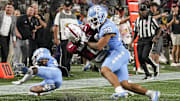 Sep 2, 2023; Charlotte, North Carolina, USA; South Carolina Gamecocks running back Juju McDowell (0) is stopped short of the end zone by North Carolina Tar Heels defensive back Alijah Huzzie (28) during the second quarter at Bank of America Stadium. Mandatory Credit: Jim Dedmon-Imagn Images