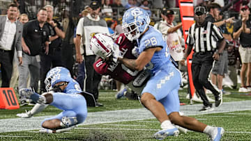 Sep 2, 2023; Charlotte, North Carolina, USA; South Carolina Gamecocks running back Juju McDowell (0) is stopped short of the end zone by North Carolina Tar Heels defensive back Alijah Huzzie (28) during the second quarter at Bank of America Stadium. Mandatory Credit: Jim Dedmon-Imagn Images