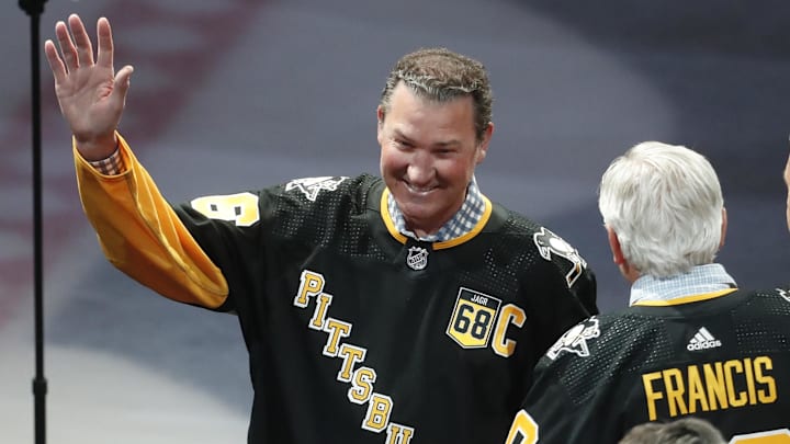 Feb 18, 2024; Pittsburgh, Pennsylvania, USA;  Pittsburgh Penguins former center Mario Lemieux gestures to the crowd during a ceremony to retire the jersey number of Penguins former right wing Jaromir Jagr (not pictured) at PPG Paints Arena. The Penguins host the Los Angeles Kings after the ceremony. Mandatory Credit: Charles LeClaire-Imagn Images