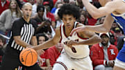 Nov 11, 2025; Louisville, Kentucky, USA;  Louisville Cardinals guard Mikel Brown Jr. (0) dribbles against Kentucky Wildcats forward Andrija Jelavic (4) during the second half at KFC Yum! Center. Louisville defeated Kentucky 96-88. Mandatory Credit: Jamie Rhodes-Imagn Images