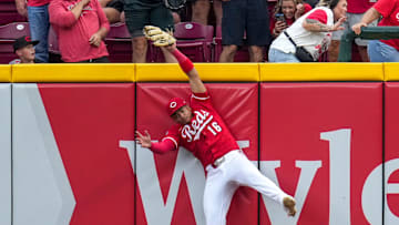 Cincinnati Reds third baseman Noelvi Marte (16) leaps to rob a home run over the wall from Pittsburgh Pirates right fielder Bryan Reynolds (10) in the ninth inning of the MLB National League game between the Cincinnati Reds and the Pittsburgh Pirates at Great American Ball Park in downtown Cincinnati on Thursday, Sept. 25, 2025. The Reds won, 2-1.