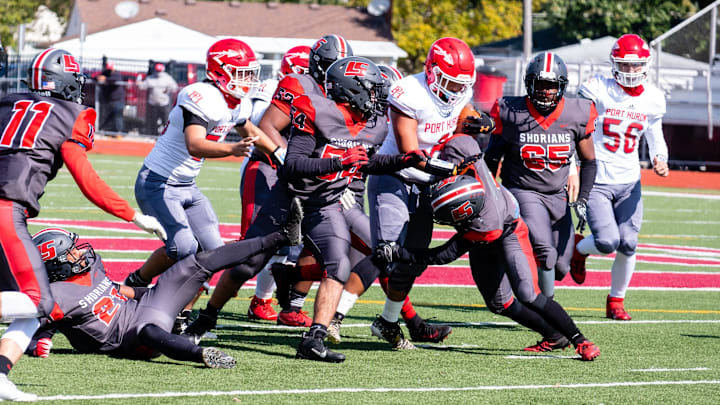 Lake Shore defenders tackle a Port Huron ball carrier in 2020.