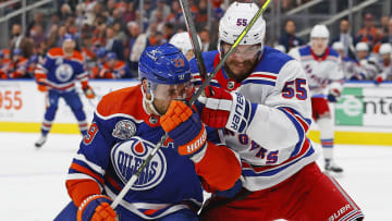 Oct 26, 2023; Edmonton, Alberta, CAN; Edmonton Oilers forward Leon Draisaitl (29) and New York Rangers defensemen Ryan Lindgren (55) battles for position during the first period at Rogers Place. Mandatory Credit: Perry Nelson-USA TODAY Sports