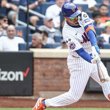 Jun 30, 2024; New York City, New York, USA;  New York Mets third baseman Mark Vientos (27) hits a two RBI double in the sixth inning against the Houston Astros at Citi Field.