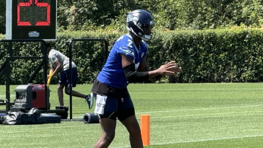Seattle Seahawks quarterback Geno Smith takes a snap during a drill at training camp.