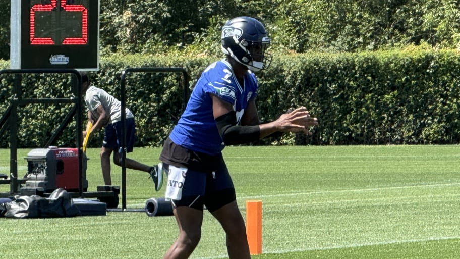 Seattle Seahawks quarterback Geno Smith takes a snap during a drill at training camp. | Corbin Smith/Seahawks On SI