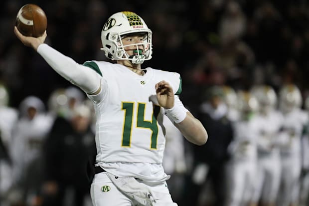 Quarterback throws football during game.