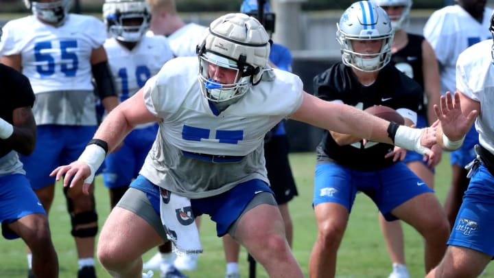 MTSU's offensive lineman Keylan Rutledge (77) comes off the line during MTSU's football practice on Wednesday, Aug. 2, 2023.