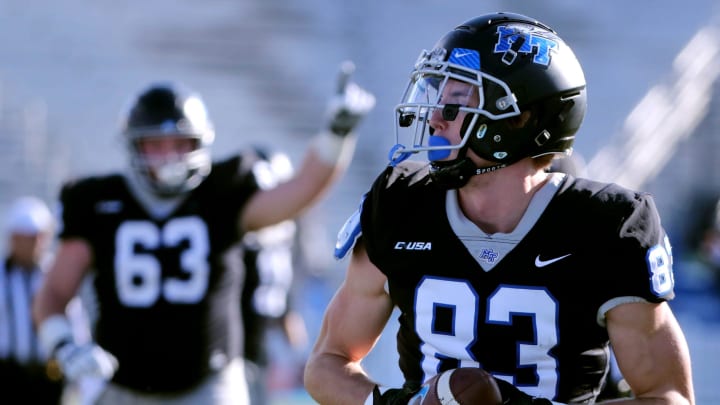 Middle Tennessee wide receiver Holden Willis (83) carries the ball in for a touchdown against UTEP as Middle Tennessee offensive lineman Wilson Kelly (63) celebrates in the background during the football game in Johnny   Red   Floyd Stadium at MTSU in Murfreesboro, Tenn. on Saturday, Nov 18, 2023.