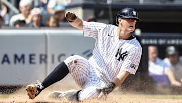 Aug 25, 2024; Bronx, New York, USA;  New York Yankees first baseman DJ LeMahieu (26) slides safely at home plate in the second inning against the Colorado Rockies at Yankee Stadium. Mandatory Credit: Wendell Cruz-Imagn Images
