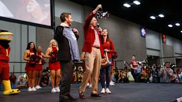 Iowa State Athletic Director Jamie Pollard hands Valero Alamo Bowl CEO Derrick Fox a plane made out of Busch Light cans during the Cyclone Spirit Rally on Thursday, Dec. 27, 2018, in San Antonio. Iowa State takes on Washington State in the Valero Alamo Bowl on Friday.
